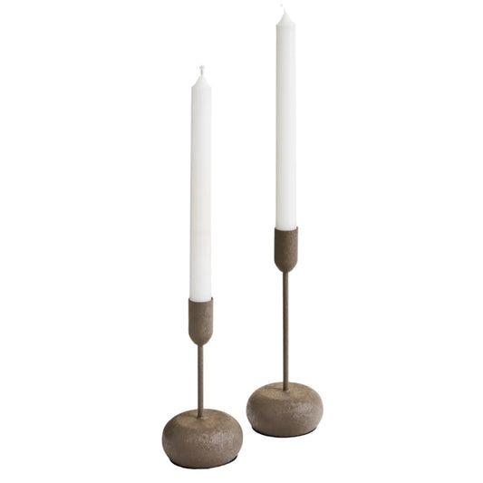 Two candle holders with candles on a white background